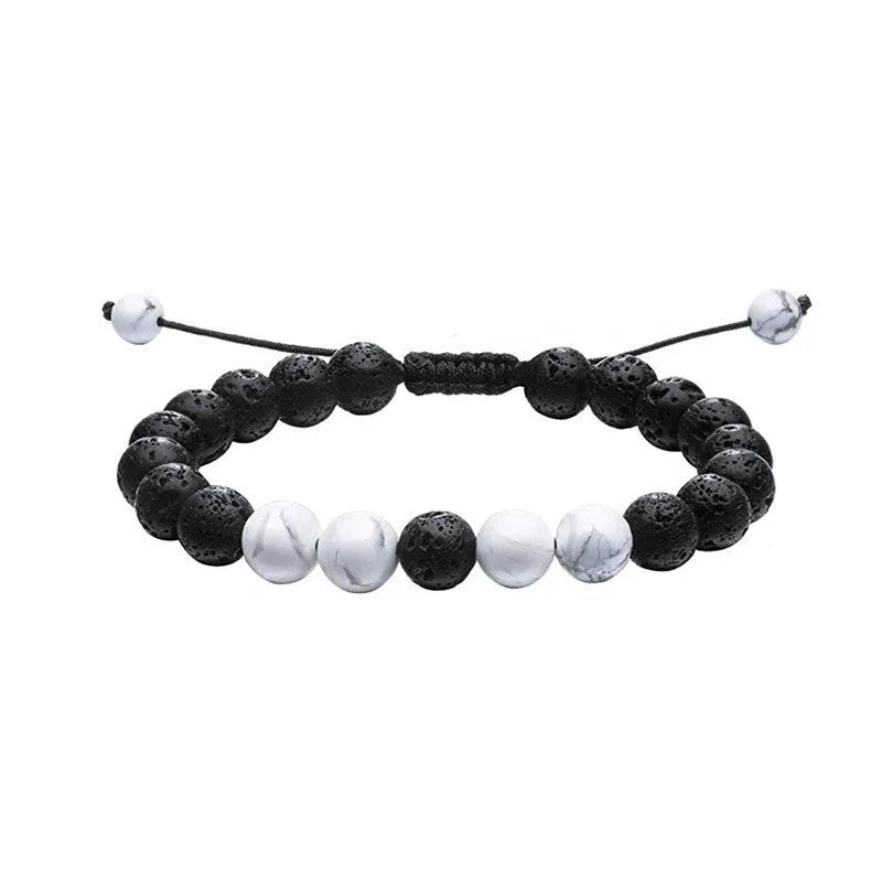 Tiger Eye and black agate geometric couple bracelets laid out as a matching set.