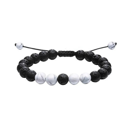 Tiger Eye and black agate geometric couple bracelets laid out as a matching set.
