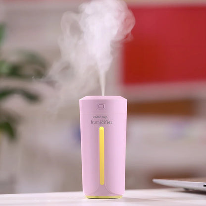 Mini USB humidifier with transparent water tank showing 7-colour LED illumination