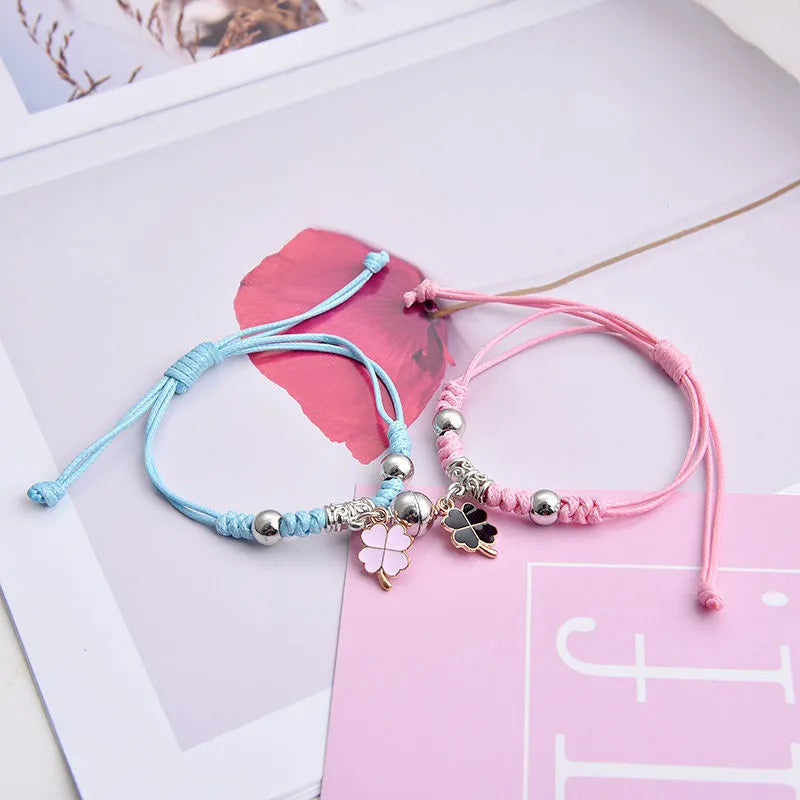 Magnetic suction couple bracelet pair in alloy with an electroplated finish, showing example designs like a crown and love lock.