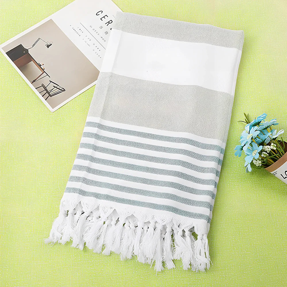 Striped Turkish beach towel showing blue and white pattern, measuring 100cm by 180cm