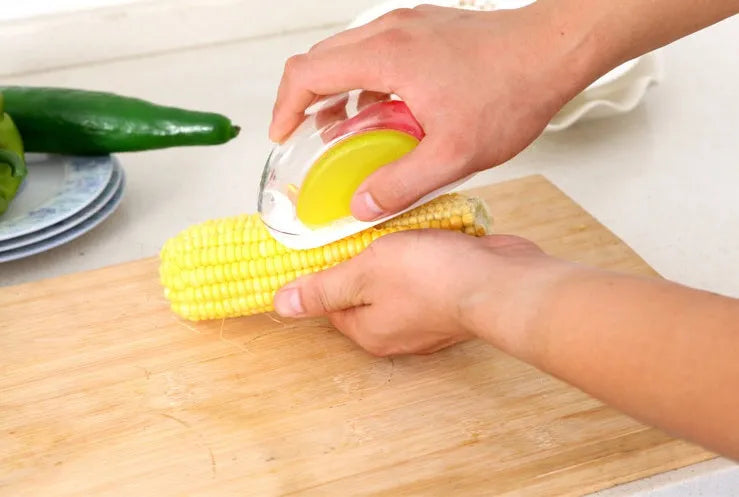 Kitchen corn separator tool with stainless steel blade and plastic case for removing kernels from corncobs