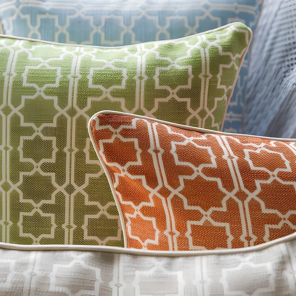 Square beige cushion cover with envelope closure on a grey sofa