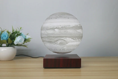 Levitating Earth or Jupiter lamp floating above base with LED illumination