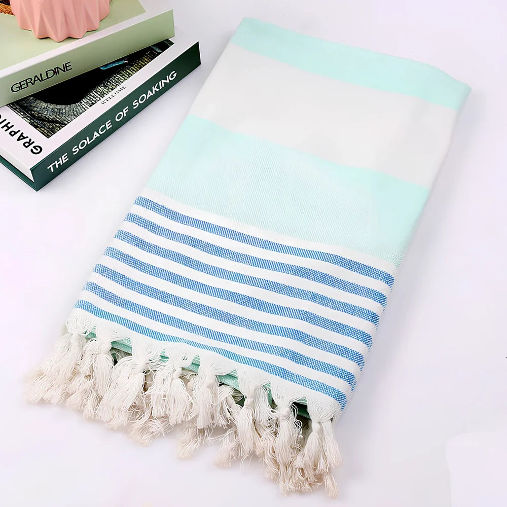 Striped Turkish beach towel showing blue and white pattern, measuring 100cm by 180cm