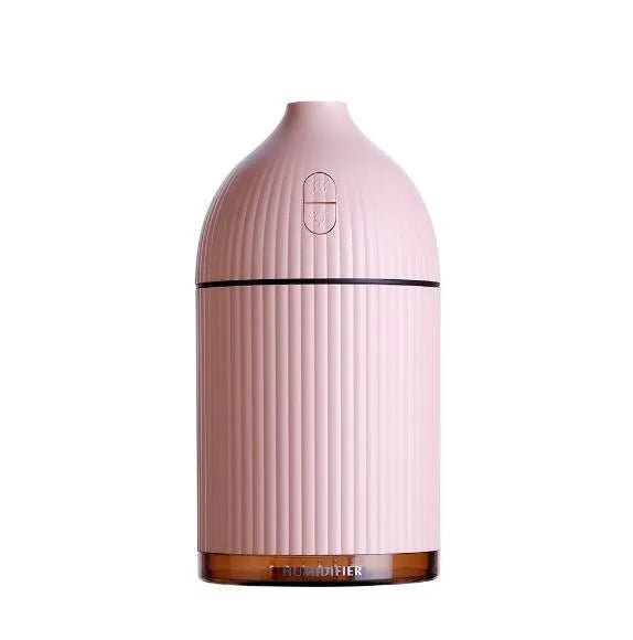 White USB-powered ultrasonic aromatherapy diffuser and humidifier with 300ml bottle and LED light on a desk.