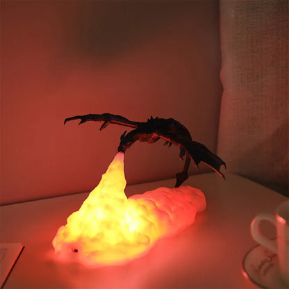 3D printed fire-breathing dragon night light with warm red LED illumination on dark surface