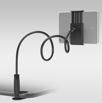 Bedside oversize flat panel handset with long arm holding a mobile phone on a table