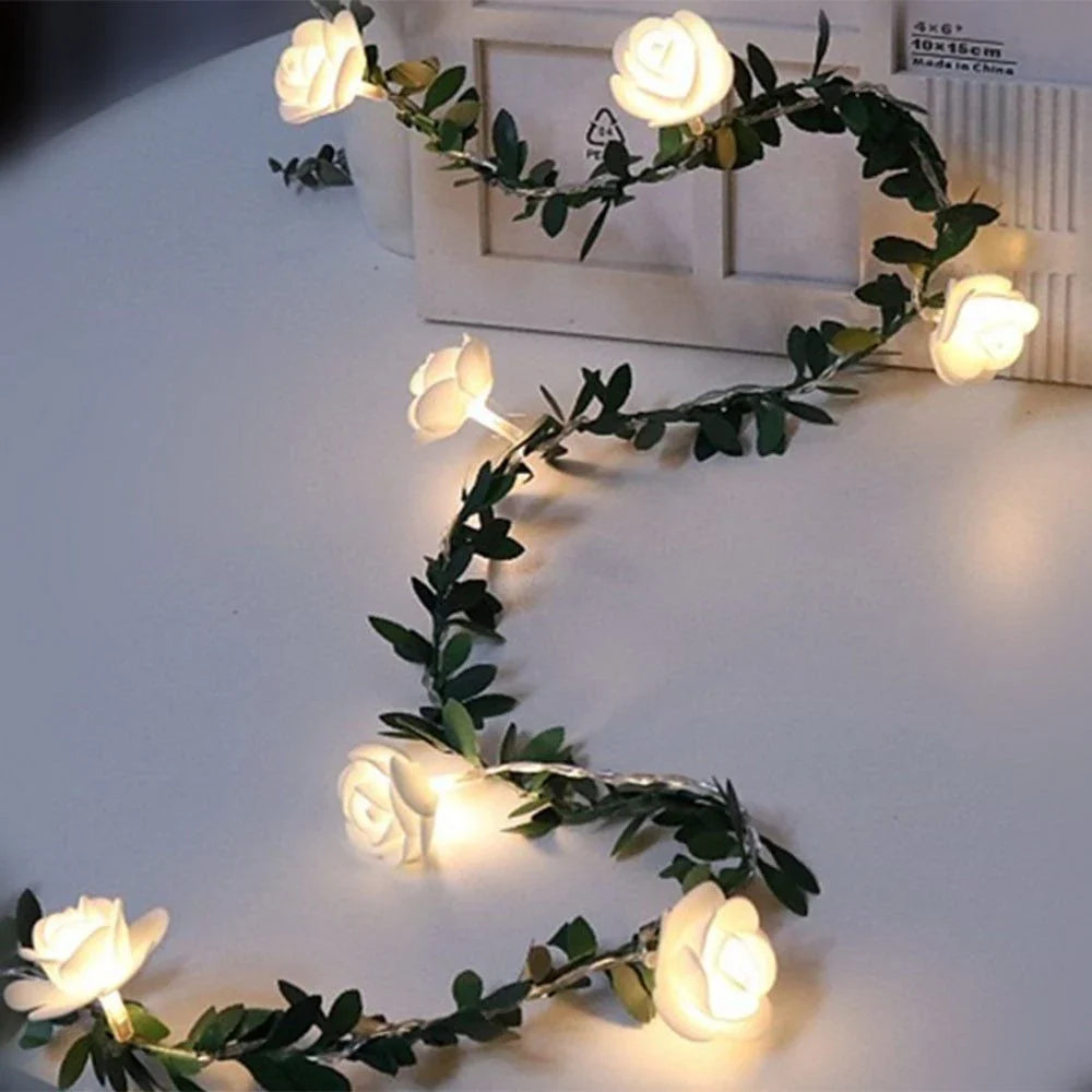Enchanting rose vine string lights with warm white LED illumination and natural green leaves and rose buds