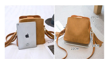 A stylish frosted tassel bucket bag with interior pockets and a versatile shoulder strap design