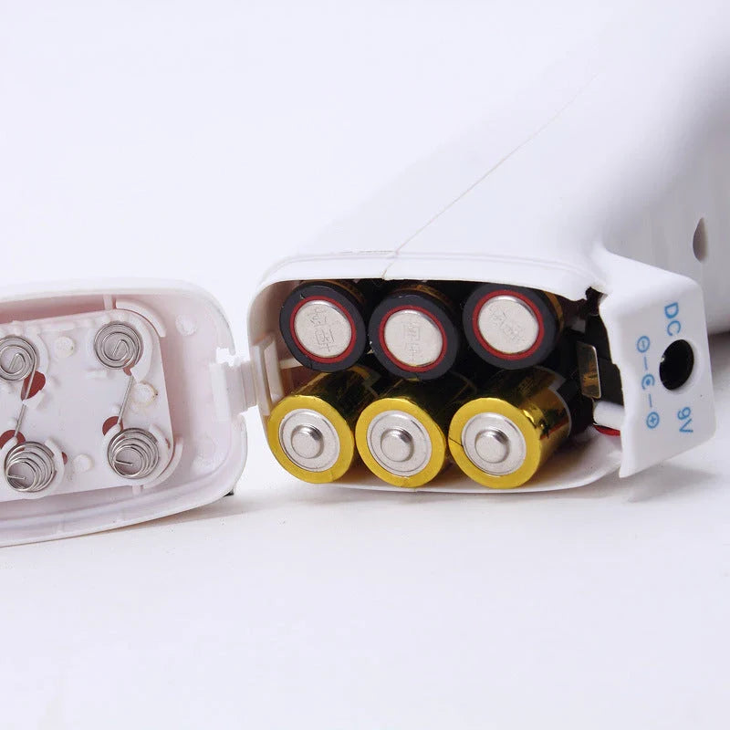 A compact, white vacuum sealing machine with various plug adapters for the UK, US, and EU markets.