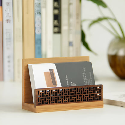 Geometric bamboo and black walnut wood business card holder on a desk.