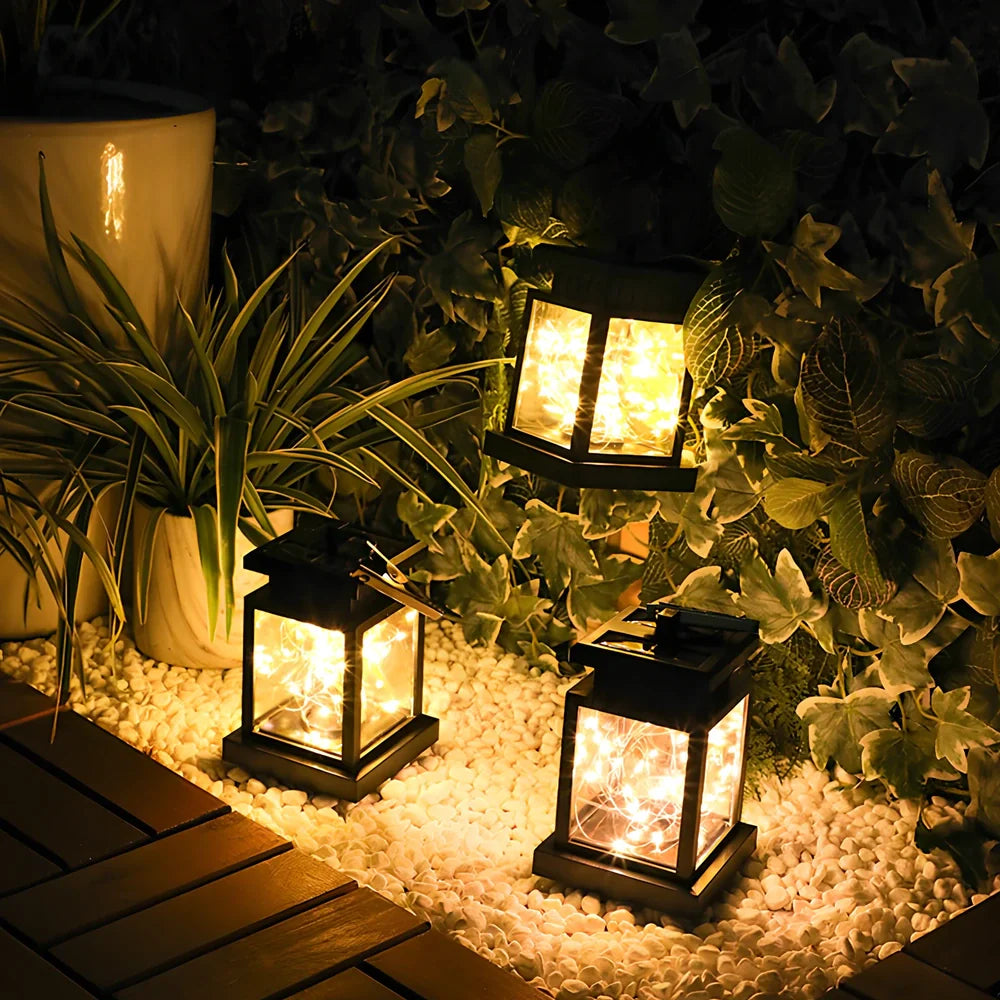 Black solar candle lamp with warm white LED illumination for outdoor gardens and patios