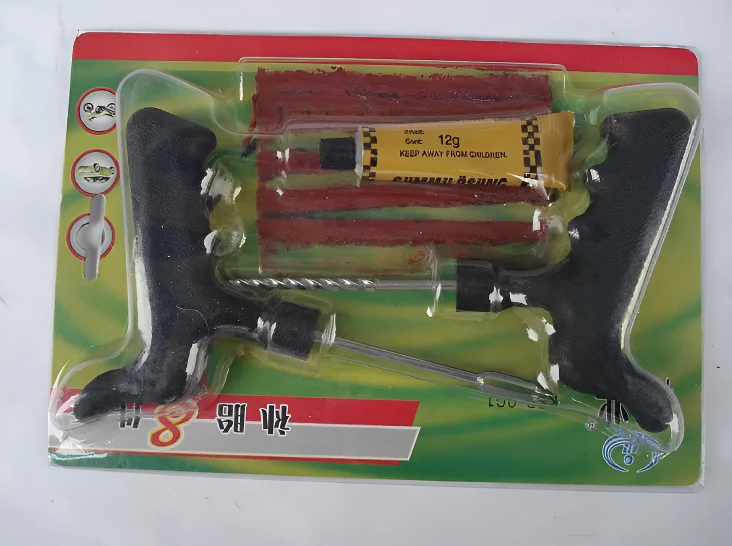 Black and yellow vacuum tyre repair tool kit with rubber strips, glue, and tools on plastic packaging.
