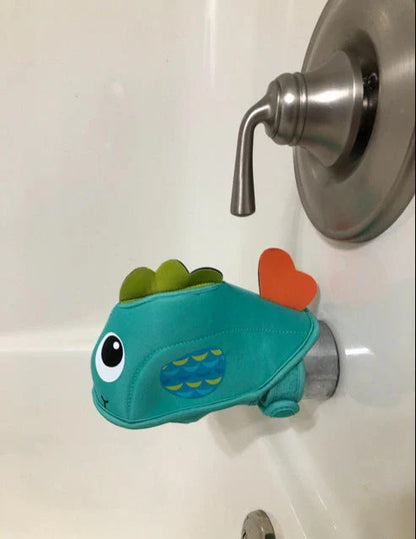 Soft, water-resistant cloth bath faucet cover in a whale design to protect baby's head during bath time