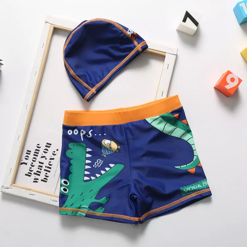 Cartoon dinosaur swimming trunks for boys in light blue, dark blue, and orange
