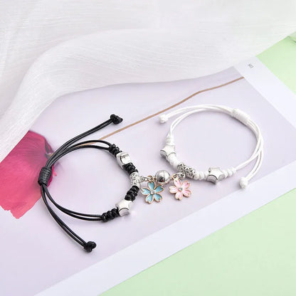 Magnetic suction couple bracelet pair in alloy with an electroplated finish, showing example designs like a crown and love lock.