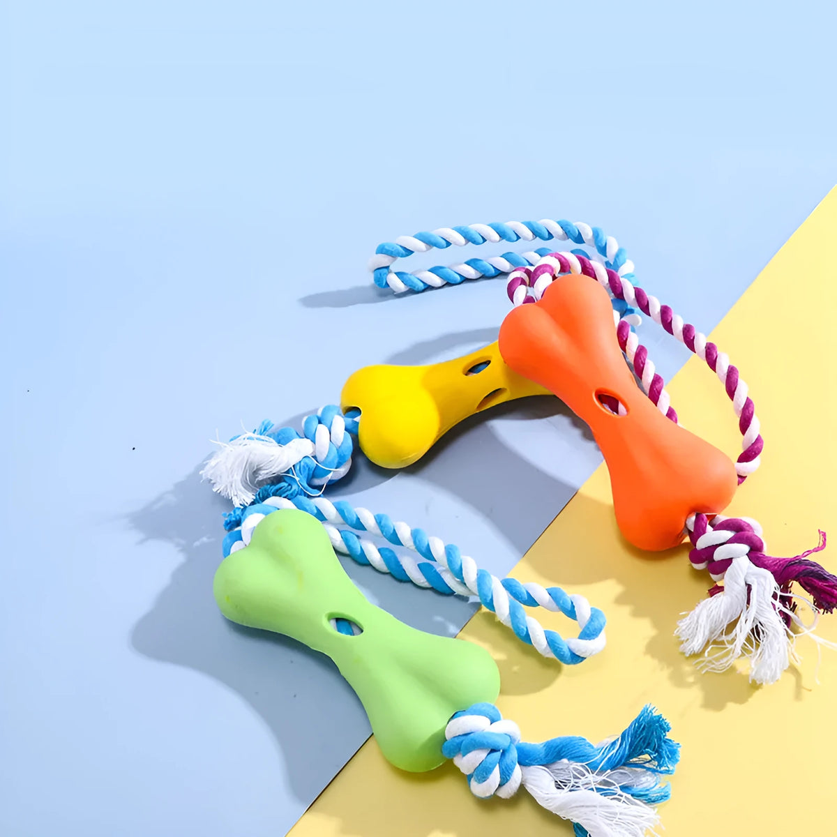 Green porous bone dog chew toy with rope knot texture for treat insertion and dental stimulation