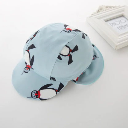 Boy's penguin print long sleeve swimsuit with matching cap for sun protection during water activities