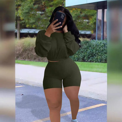 Women's long sleeve off-the-shoulder top and shorts two-piece set in a solid colour.