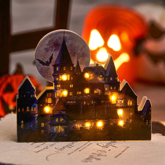 LED illuminated castle ornament with turrets and textured surfaces on desktop