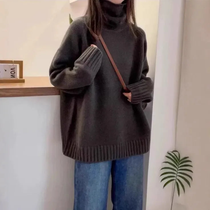 Women's turtleneck sweater in loose fit with thick curling pile collar, available in red, camel, grey, and black colours