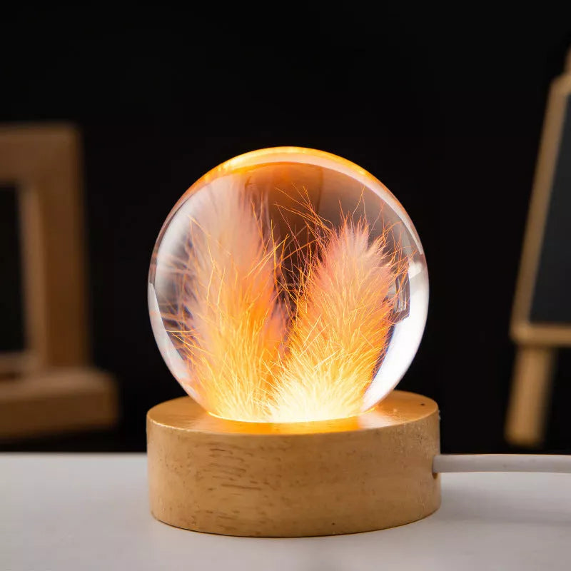 LED Dandelion Crystal Ball Night Light with oak base emitting soft glow