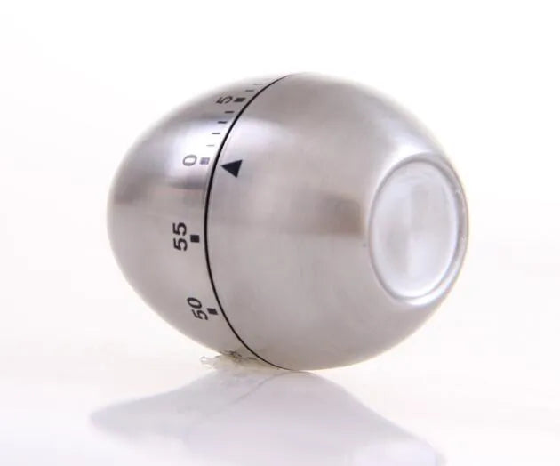 Stainless steel mechanical kitchen timer with egg-shaped design on kitchen counter