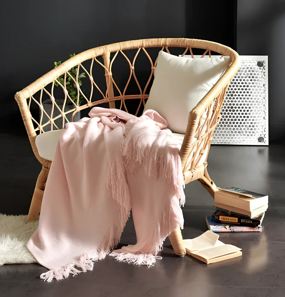 130x150cm knitted acrylic blanket with 10cm fringe detailing in beige colour draped over sofa