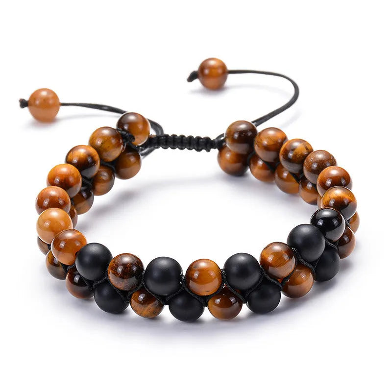 Tiger Eye and black agate geometric couple bracelets laid out as a matching set.