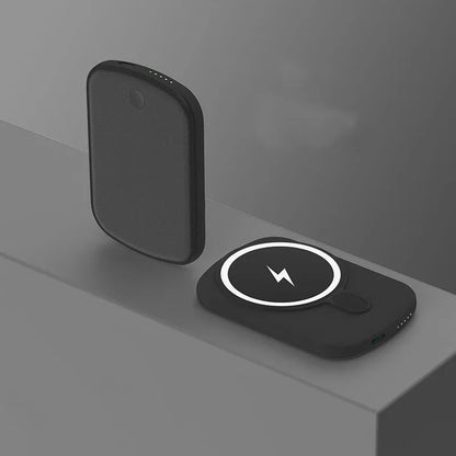 Magsafe magnetic wireless power bank in black, attached to an iPhone.