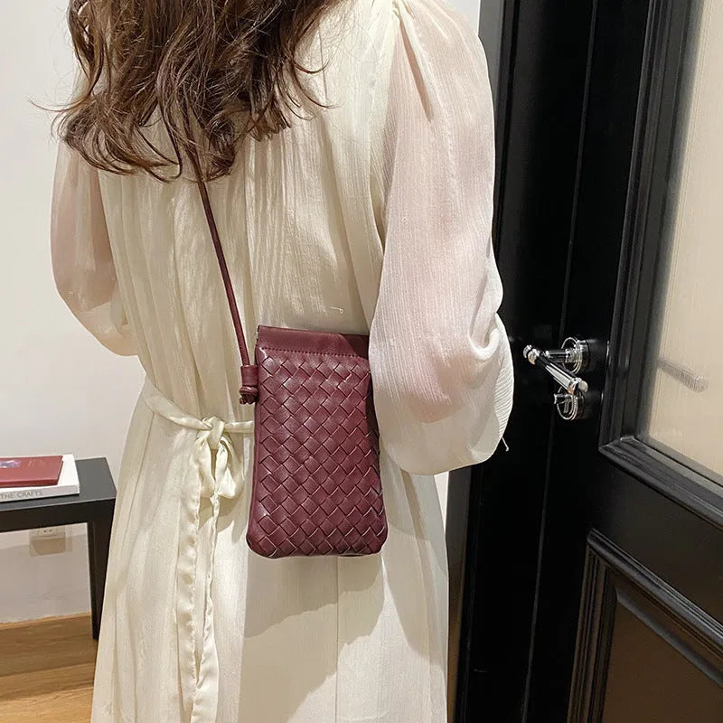 Vertical square vintage weave crossbody bag in multiple colours showing internal dark cell phone pocket.