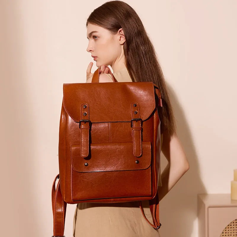 Genuine cowhide leather backpack for women in black, brown, or coffee, showing hard-textured two-layer construction.