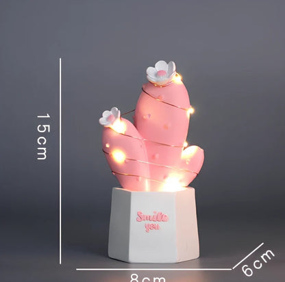 Cactus-shaped resin night light in gold finish measuring 15cm tall with warm LED glow