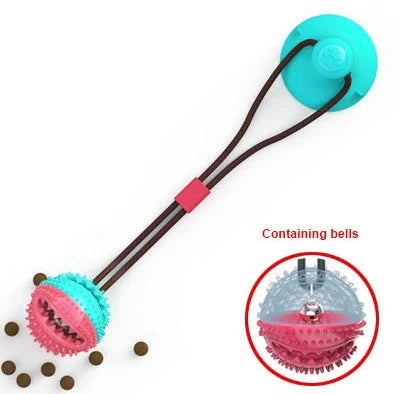 Red and blue silicone dog ball toy with suction cup attached to tile surface