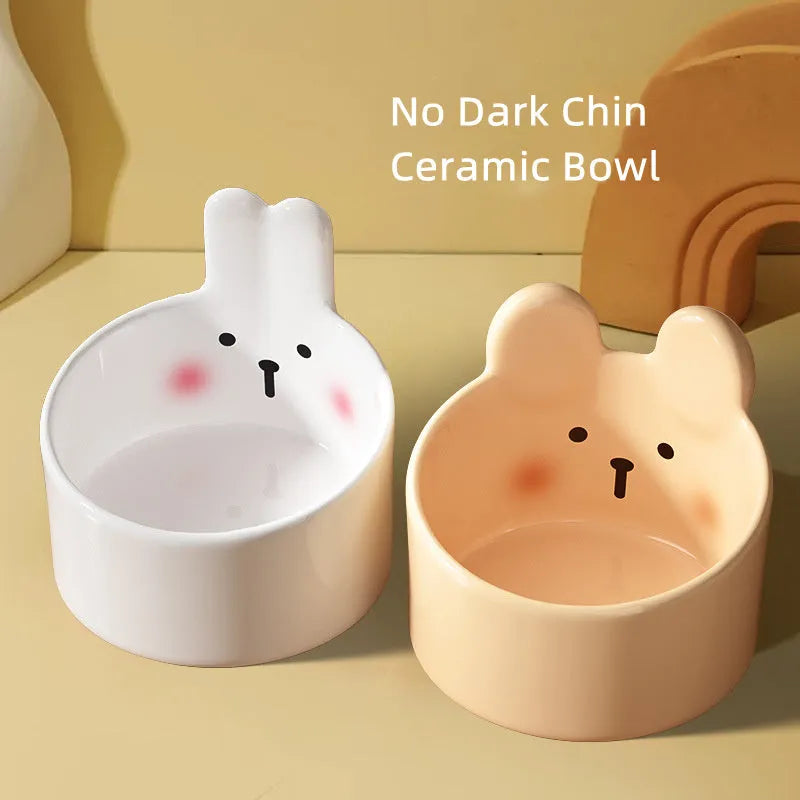 Pet ceramic feeding bowl set with neck protection design, crafted from easy-clean ceramic material in two sizes and charming animal motifs for dogs and cats