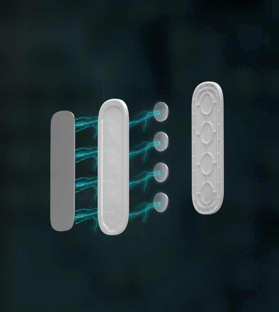 White magnetic socket organiser mounted on wall holding power board with cables organised