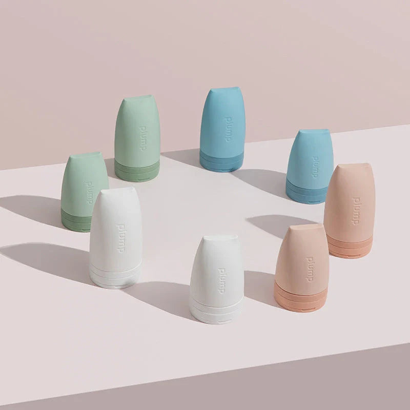 Compact silicone travel bottles for cosmetics, available in multiple vibrant colors and sizes for convenient on-the-go beauty storage and application.