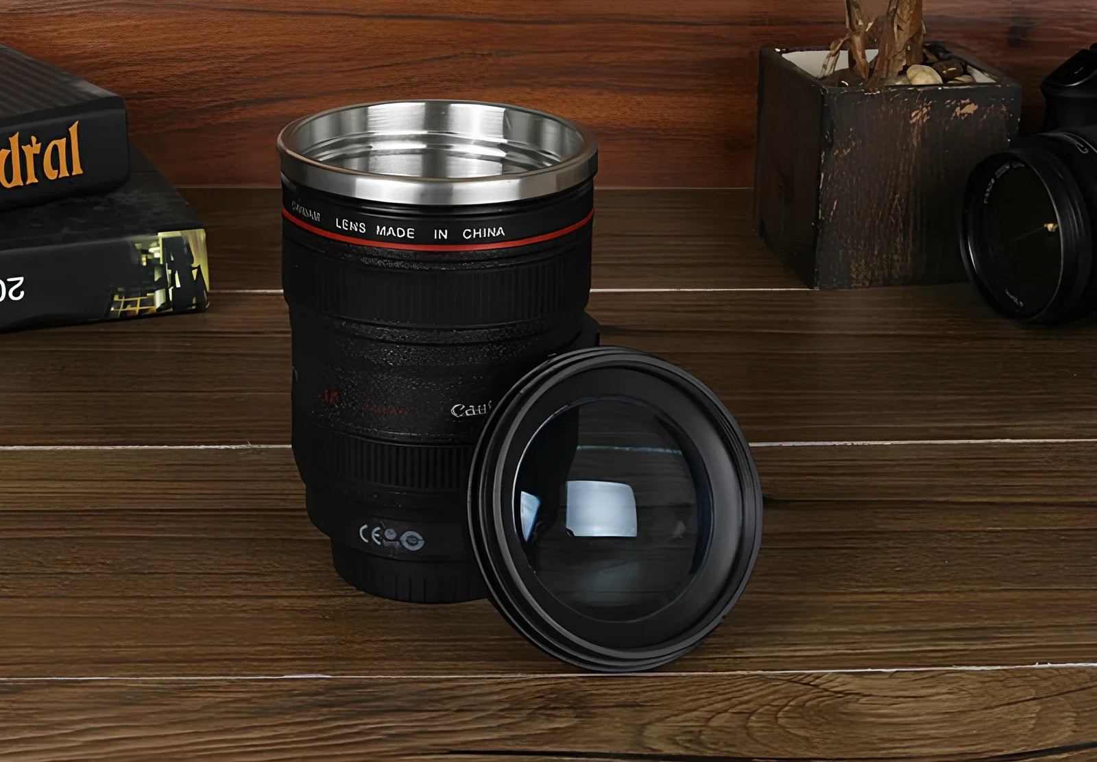 Self-stirring camera lens mug with stainless steel construction and automatic mixing button