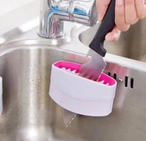 Blue kitchen brush with utensil slots and suction cup for fruit and vegetable cleaning