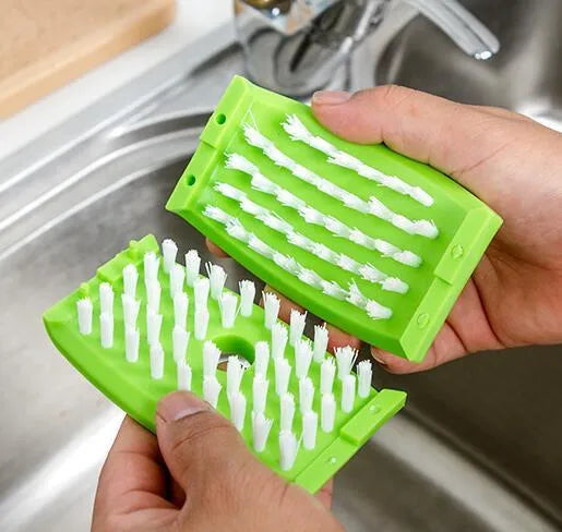 Blue kitchen brush with utensil slots and suction cup for fruit and vegetable cleaning