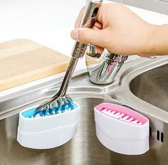 Blue kitchen brush with utensil slots and suction cup for fruit and vegetable cleaning