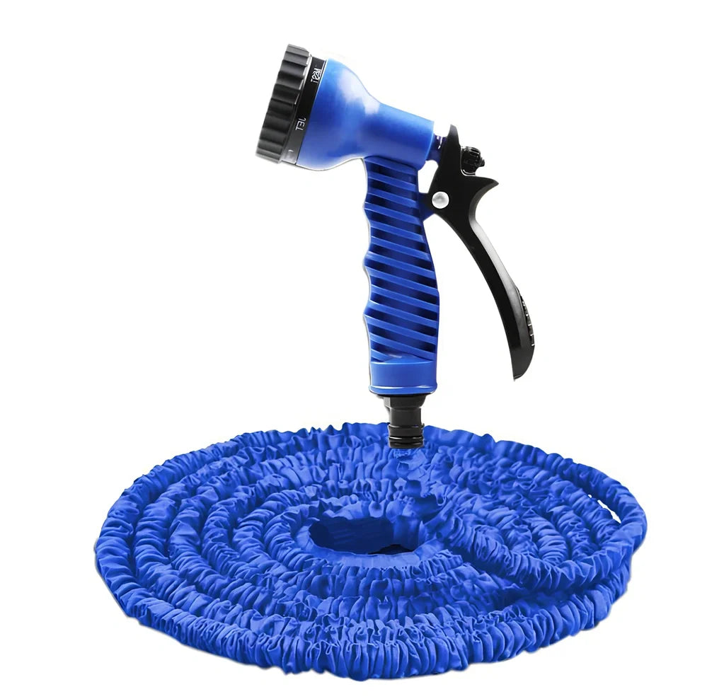 Expandable flexible water hose with spray gun showing green colour and extended length with water spraying in cone pattern
