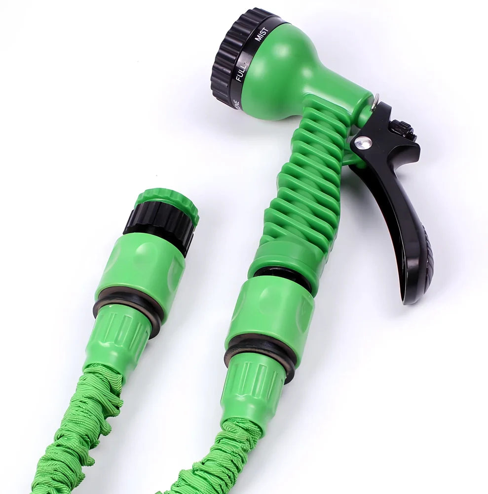 Expandable flexible water hose with spray gun showing green colour and extended length with water spraying in cone pattern