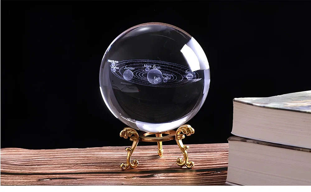 Solar system crystal ball showing planets inside K9 optical crystal sphere on metallic base