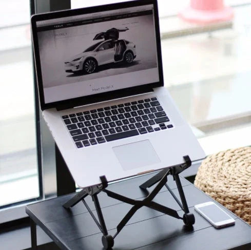 Stylish desktop computer stand with a sleek black metal frame and a wooden surface, elevating a laptop or desktop computer to an optimal viewing height.