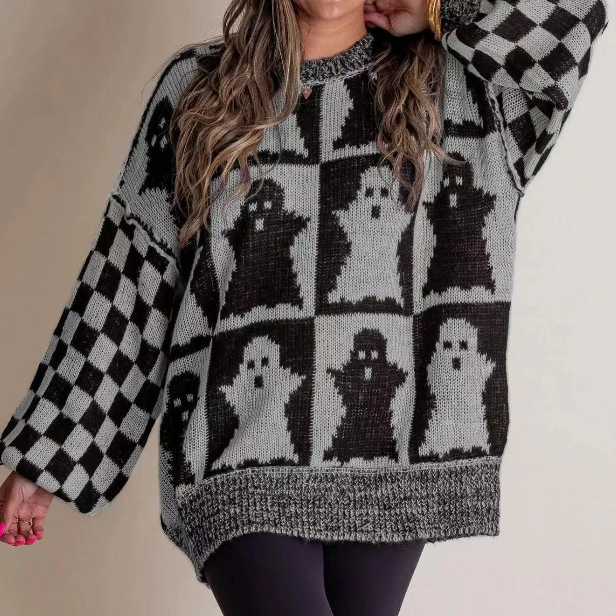 A stylish Halloween sweater featuring a unique pumpkin and ghost graphic design, available in a variety of fashion-forward colors.
