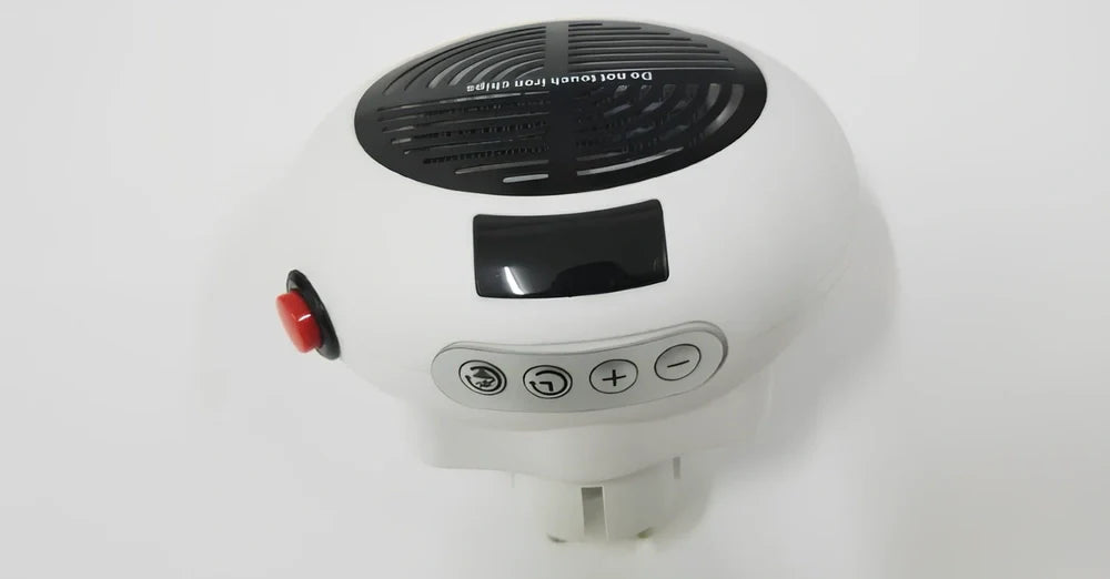 Black portable mini heater with temperature control dial showing 15-32°C range and compact design