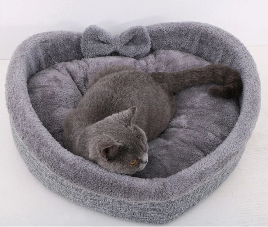 Cozy heart-shaped pet bed in grey and pink colors, suitable for cats and small dogs