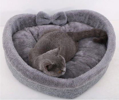 Cozy heart-shaped pet bed in grey and pink colors, suitable for cats and small dogs